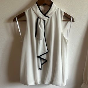 BCX white puffy blouse with levered front fringe and black lining.